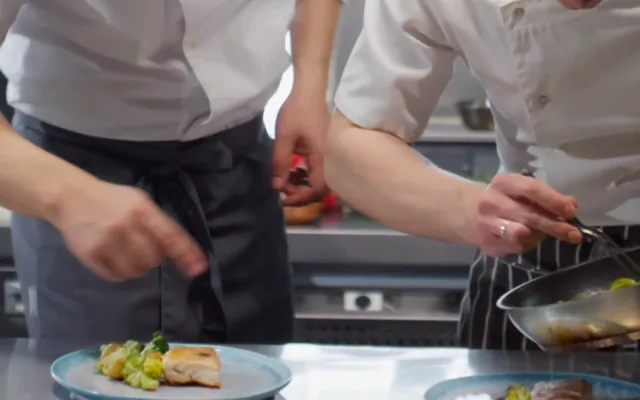 Chefs plating a dish ready for the floor